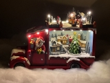 Christmas village/scene: Santa Claus in truck with LED lights, music and rotating tree, includes power adapter; available 10/15/2022