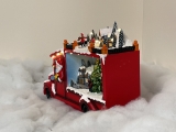Christmas village/scene: Santa Claus in truck with LED lights, music and rotating tree, includes power adapter; available 10/15/2022
