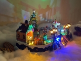 Christmas village/scene: ice skating rink with LED lighting, music and moving ice skaters, including power adapter; available from 15.10.2022